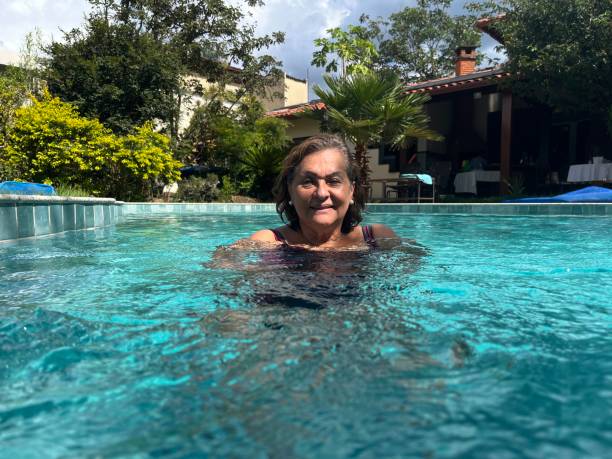 istock Senior Hispanic woman in swimming pool 2068461459