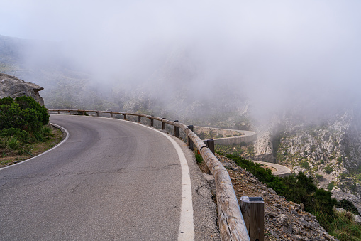 Clouds on the famous winding road in Sa Calobra on the island of Mallorca, Spain. Dangerous road turn in the clouds Travel around the island.