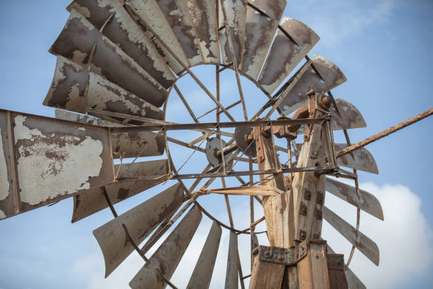 istock Old fashioned vintage windmill with metal sails and timber construction 2068472105