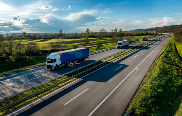 istock Transportation Trucks in lines passing 2068484210