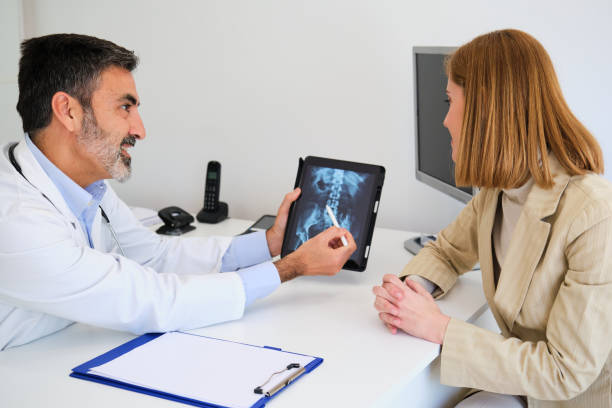 istock Doctor explaining x-ray to his female patient before a surgery for a broken hip. 2068520414