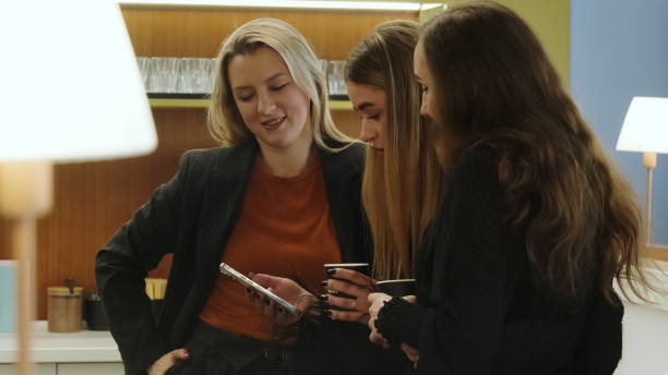 istock Businesswomen take break during work in bright office space 2068530127