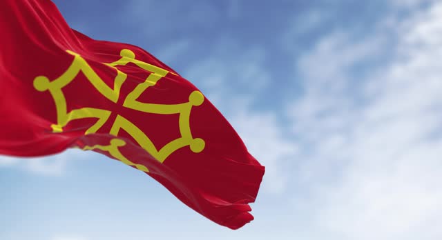 The flag of Occitanie region waving in the wind on a clear day