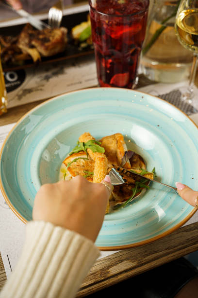 istock Female eating fried fish with baby corn 2068558990