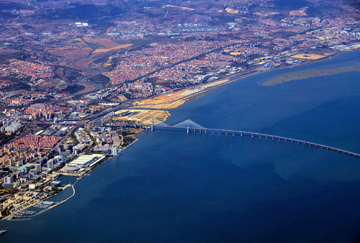 Lisbon, Portugal: aerial view of Lisbon - eastern part of the city, looking north seen from above the Mar da Palha (Sea of Straw) inland sea in the Tagus River estuary. Around the Vasco da Gama bridge lie the Expo (Park of Nations), Moscavide, Portela, Olivais, Bobadela from Sacavém areas.