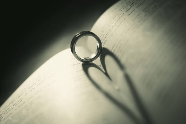 istock Wedding ring on the pages of a book in a heart shape 2068615565