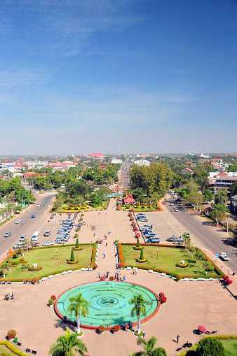 Vientiane, Laos: garden with Chinese built musical fountain of Patuxai square seen from above - Vientiane skyline, looking NE along Kaysone Phomvihane Avenue.