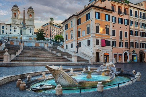 Fountain of Boat and Spanish steps with Trinita dei Monti church in Rome, Italy