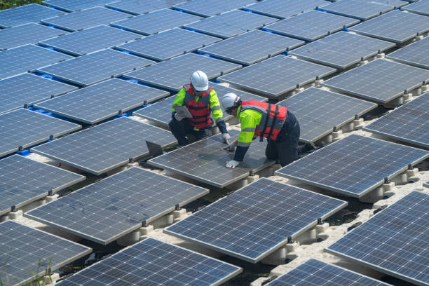 istock engineers check floating solar cell power plant with solar cell generate the electric on the lake. Floating solar panels and cell platform on the water ecological energy. Alternative renewable energy. 2068637821