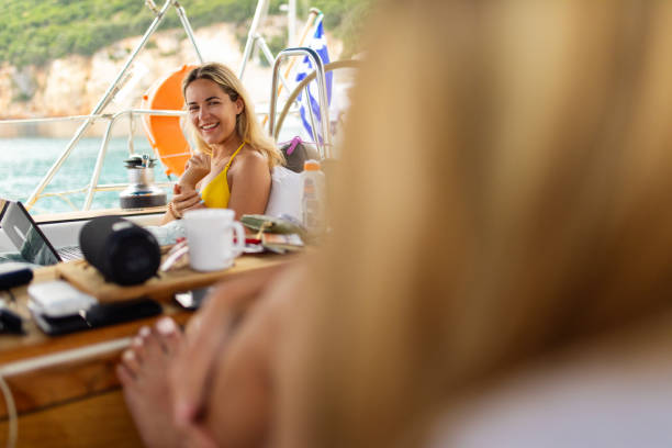 istock Young attractive woman using laptop on a sailboat 2068652884