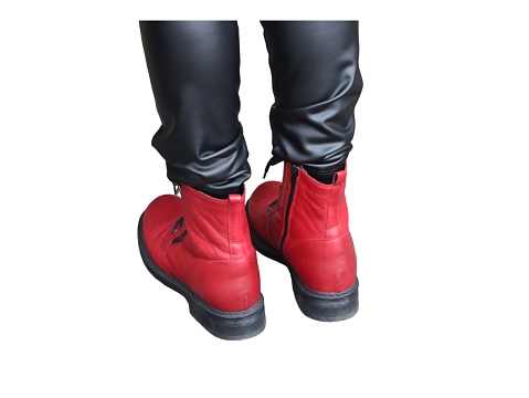 Pair of vibrant red leather boots isolated on a white backdrop, displaying fashion footwear