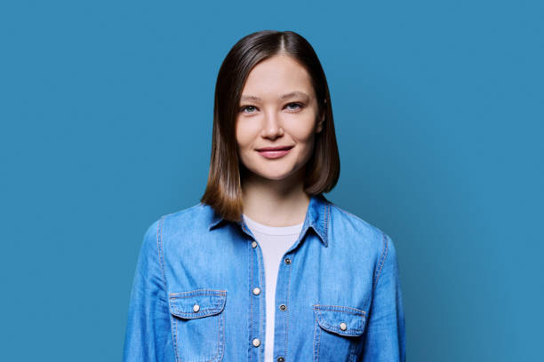 istock Young smiling attractive woman on blue background 2068678806