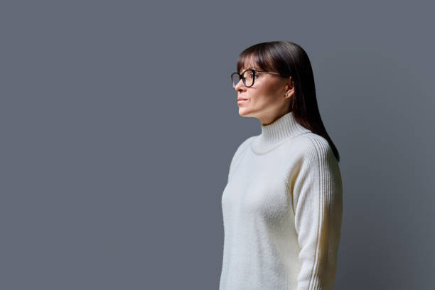 istock Profile view of middle aged serious woman, gray background, copy space 2068681934
