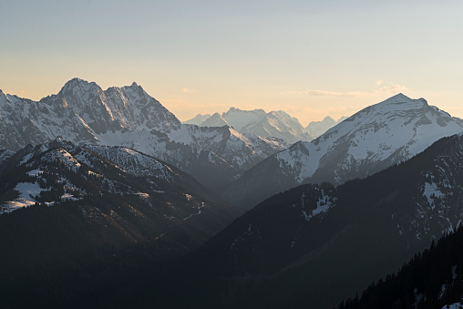 Snowy Mount Soiernspitze and Mount Woerner in the Karwendel mountains with Wetterstein range behind in warm evening light