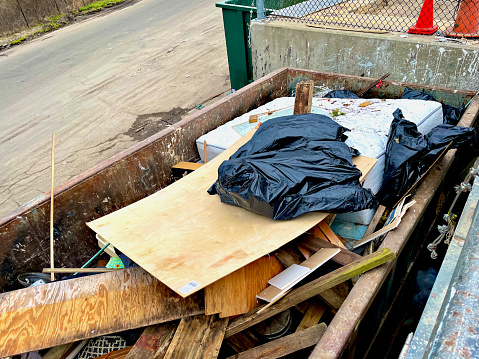 Fairfax, Virginia, USA - February 24, 2024: Plywood and other material dumped into an industrial sized container await transportation at Fairfax County’s “I-66 Transfer Station”.