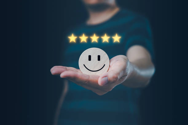 istock Satisfaction concept, Man holding circular wooden board with smiling face icon 2068723971