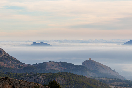 Fog drifting over the peaks and trails of Monserrat, Spain.