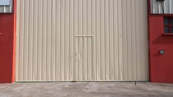 White metal door in metal industrial building