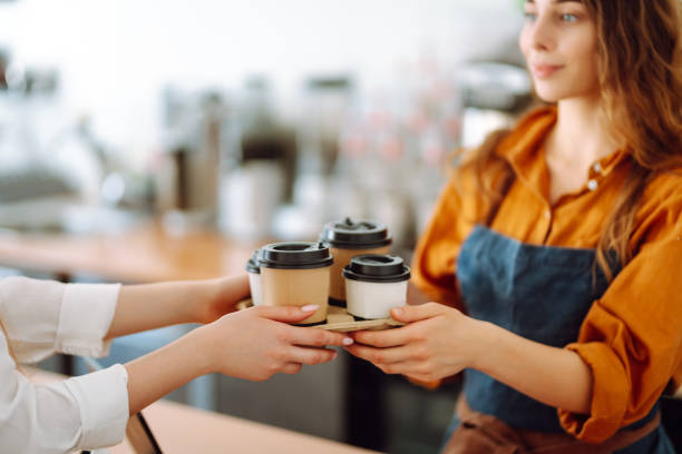 istock Female barista giving order to client 2068805723