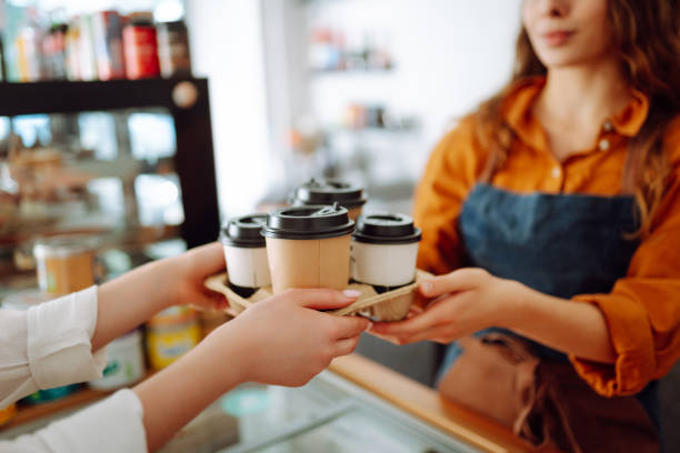istock Female barista giving order to client 2068806225