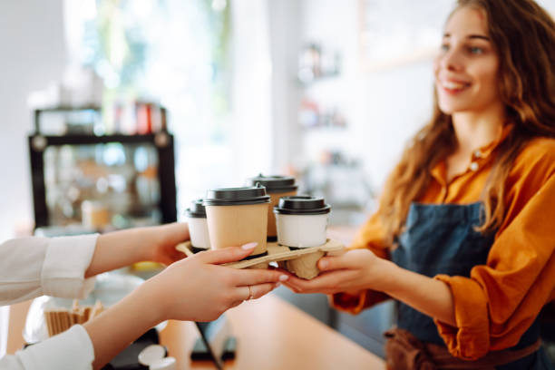 istock Female barista giving order to client 2068806231