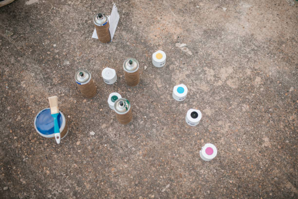 Close-up of different colored sprays and buckets of paint, used by street artists to draw graffiti