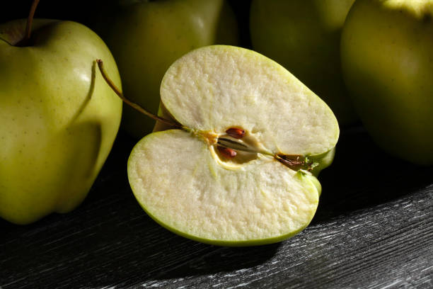 istock sliced apple on black wood 2068829100