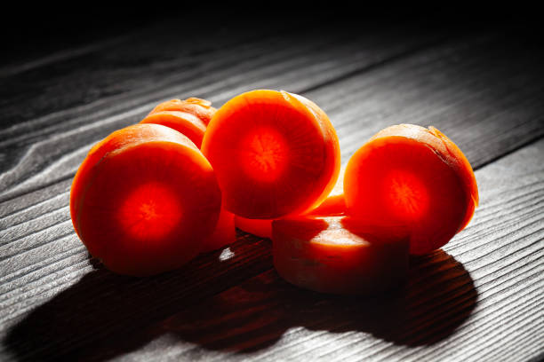sliced carrot on black wood background
