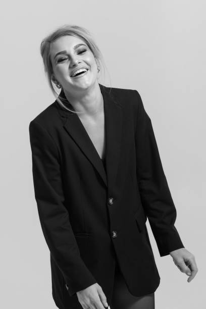 istock Beautiful woman with black suit studio portrait on white background 2068860257