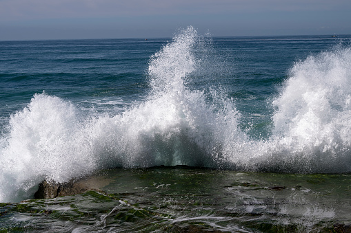 Aerial scenic view of rugged coastline and Pacific Ocean surf