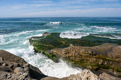 Aerial scenic view of rugged coastline and Pacific Ocean surf