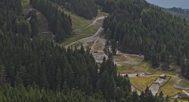 Whistler BC Canada Aerial v15 zoomed birds eye view drone flyover capturing mountain bike park's challenging slopes, uphill lift and lush forested surroundings - Shot with Mavic 3 Pro Cine - July 2023