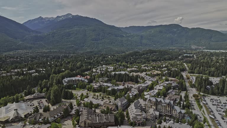 Whistler BC Canada Aerial v1 drone flyover Blackcomb Park towards the town center capturing picturesque resort village nestled amidst the forested mountains - Shot with Mavic 3 Pro Cine - July 2023