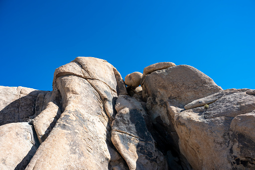 Tall, sandstone cliffs under blue sky Joshua Tree National Park