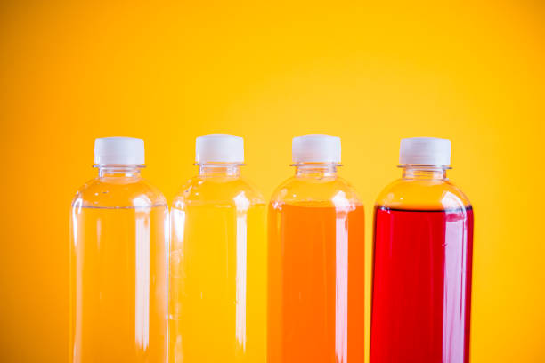 A captivating array of PET1 bottles stands out against a bold orange background, offering a versatile image for various creative projects