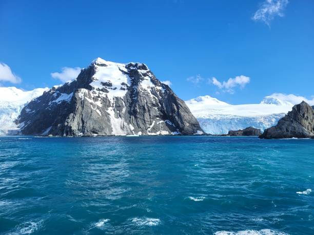 istock Bright blue ocean in Antarctica, Elephant island, snow covered cliffs, huge glaciers on a bright sunny day, blue sky and white clouds, icebergs floating 2068916302