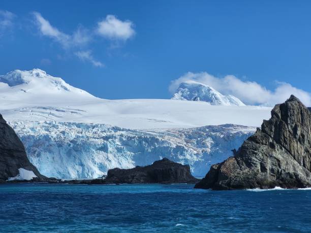 istock Bright blue ocean in Antarctica, Elephant island, snow covered cliffs, huge glaciers on a bright sunny day, blue sky and white clouds, icebergs floating 2068916316