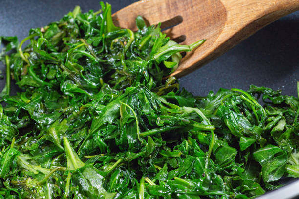 istock Wilted arugula or rocket salad, preparing a side dish in frying pan, horizontal 2068921734