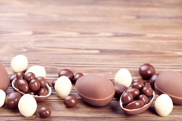 istock Easter chocolate eggs with candies on brown wooden table 2068958298