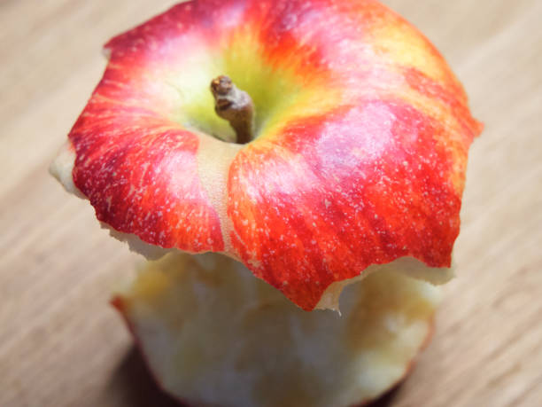 istock Red apple core on a wooden background. A bitten apple close-up. 2068967960