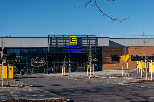 Neumarkt, Germany - January 28, 2024: Store of the German supermarket corporation EDEKA. It was founded in 1898 and is headquartered in Hamburg. Sunny winter day. Location: Neumarkt, Bavaria, Germany.