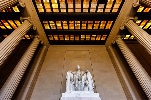 Abraham Lincoln statue landmark with marble ceiling in Lincoln Memorial in Washington, D.C. Low angle view