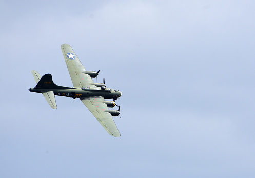 Ickwell, Bedfordshire, England - July 02, 2023: Vintage  B-17 Flying Fortress G-BEDF Sally B in flight blue sky.