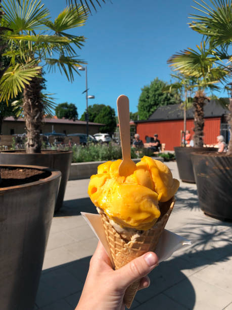 istock A young woman holding a mango ice cream cone 2069034226