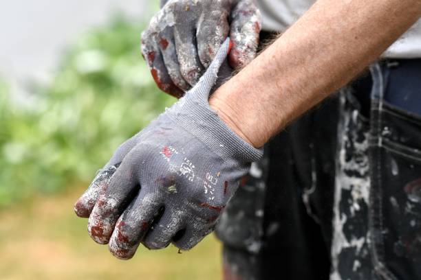 istock A man putting on protective gloves for painting 2069039482