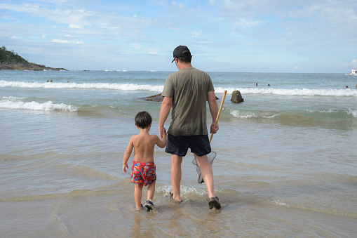 father with son the sea