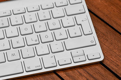 Closeup macro of a white and modern keyboard for a computer or laptop