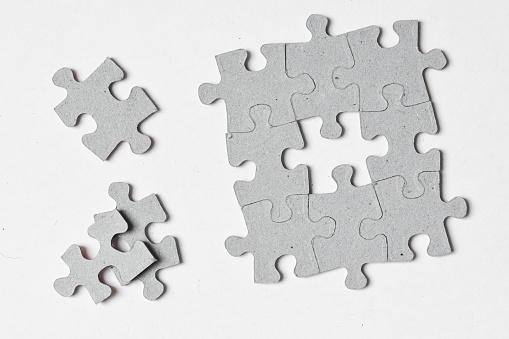 Photo of jigsaw puzzle pieces fit together on white background