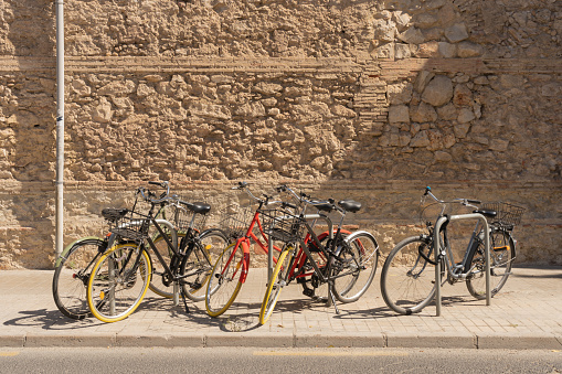 Bicycle parking. Healthy mode of transportation. Without pollution. Horizontal. stone wall background. texture. sunlight