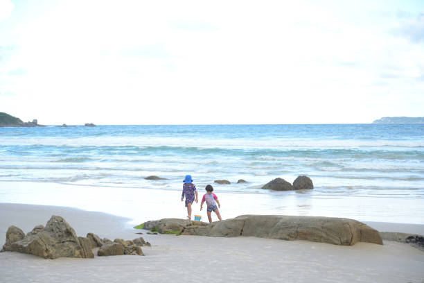 istock brothers playing by the sea 2069060686